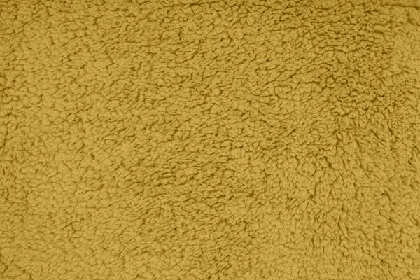 Ouro sherpa texturizado fundo material de tecido de pelúcia — Fotografia de Stock