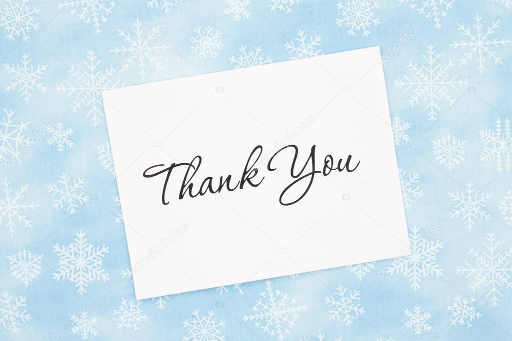 Thank you message with white greeting card with a blue snowflake