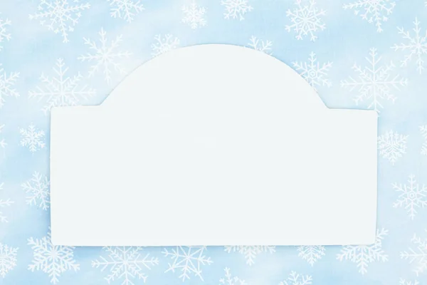 Blank white wood sign with a blue snowflake background — Stock Photo, Image