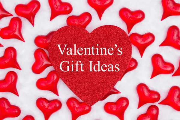 Valentine's Gift Ideas message on glitter heart with red hearts — Stock Photo, Image