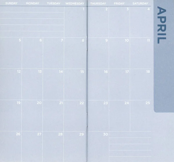 Close up of a blue pocket calendar for April that is blank — 스톡 사진