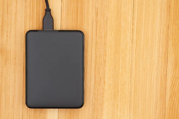 Black portable hard drive with a cable — 스톡 사진