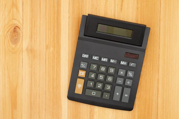 Calculator with a display on wooden desk — Stock Photo, Image