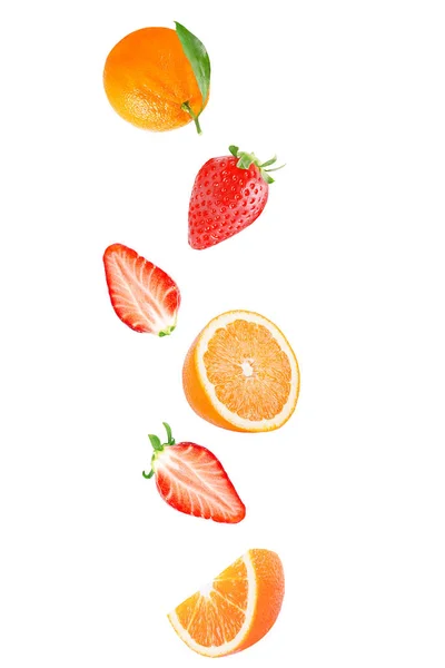 Falling strawberry and orange isolated on white