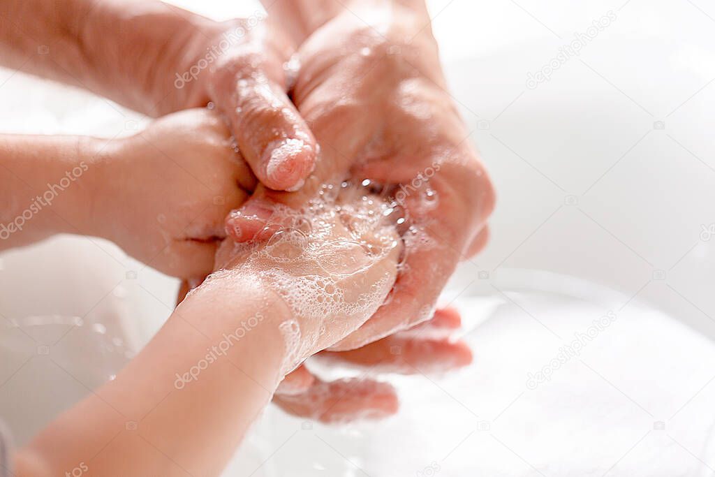 Father and his little son's washing hands with soap. Close-up. Anti coronavirus prevention measures. covid-19. Copy space.