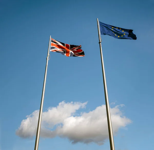 UK and EU flags in the clouds as brexit looms