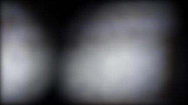 Arkaplanda renkli, bulanık, soyut, hareket eden ışık noktaları.