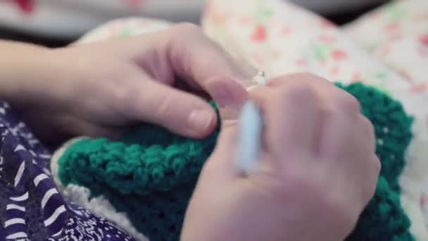 Gros plan des mains féminines tricot fil de laine blanc et vert 