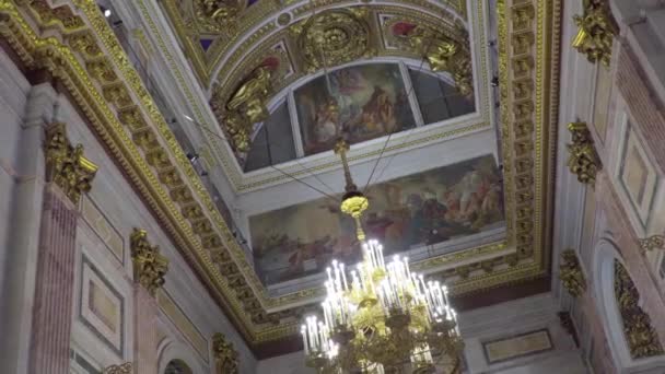 Saint-Pétersbourg, Russie - 24 février 2020 : Cathédrale Saint-Isaacs, bel intérieur, peintures murales, sculptures, moulures en stuc. Les touristes marchent, regardent et prennent des photos . — Video