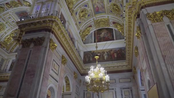 Saint-Pétersbourg, Russie - 24 février 2020 : Cathédrale Saint-Isaacs, bel intérieur, peintures murales, sculptures, moulures en stuc. Les touristes marchent, regardent et prennent des photos . — Video