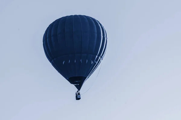 Hot air balloon is flying at sunrise. Toned blue trend color of the year 2020 — 스톡 사진
