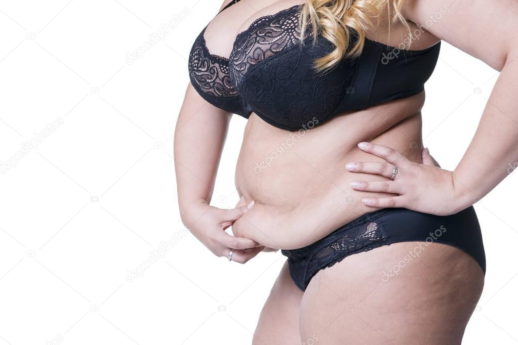 Plus size model in black lingerie, overweight female body, fat woman with flabby stomach isolated on white background