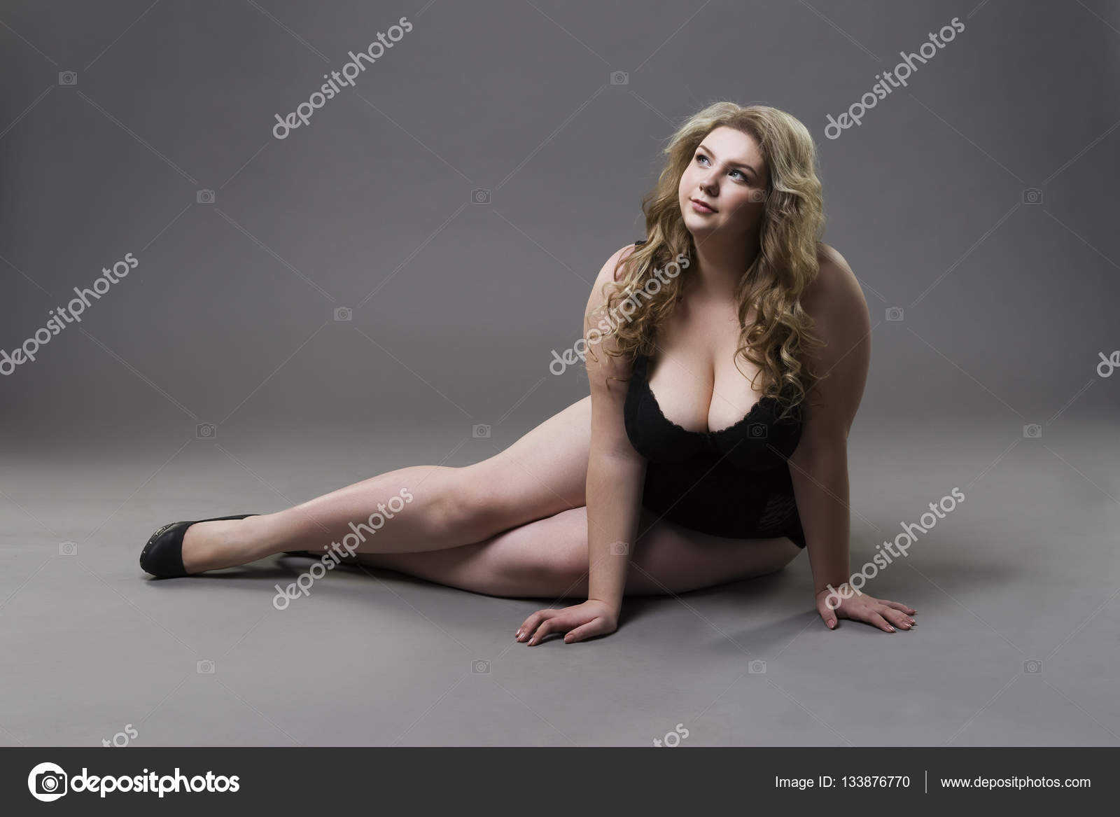 Young beautiful blonde plus size model with big natural breasts in  underwear, xxl woman on gray studio background Stock Photo by ©starast  133876770