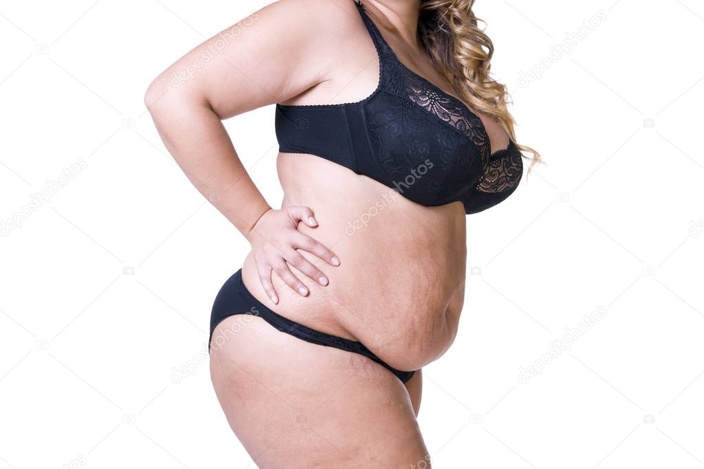 Plus size model in black lingerie, overweight female body, fat woman with flabby stomach isolated on white background