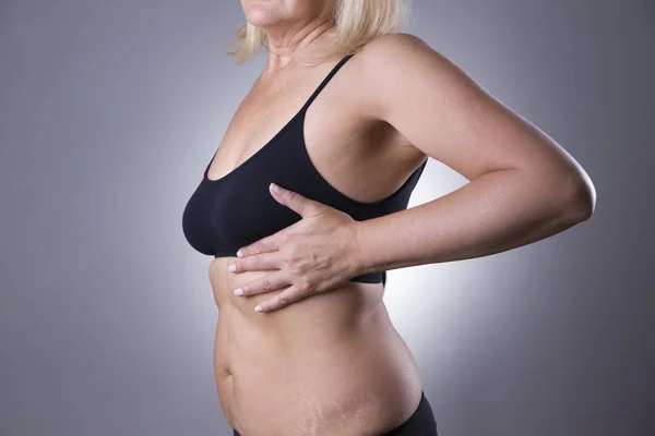 Breast test, woman examining her breasts for cancer, heart attack