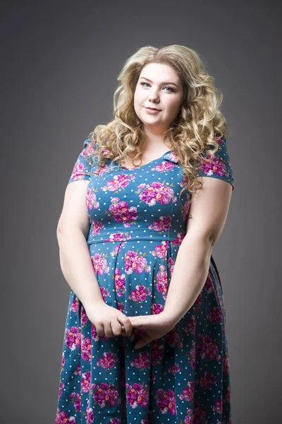 Young beautiful happy blonde plus size model in dres, xxl woman portrait on gray studio background — Stock Photo, Image