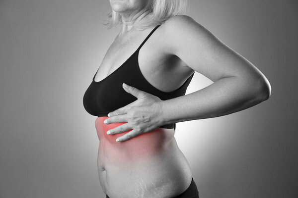Breast test, woman examining her breasts for cancer, heart attack