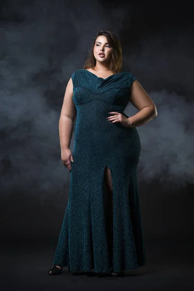 Plus size fashion model in green evening dress, fat woman on black background, overweight female body — Stock Photo, Image