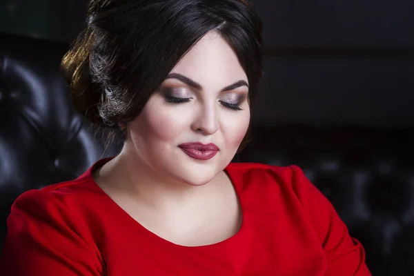 Plus size fashion model in red dress with professional make-up and hairstyle — Stock Photo, Image