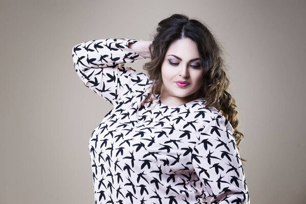 Plus size fashion model in casual clothes, fat woman on studio background, overweight female body
