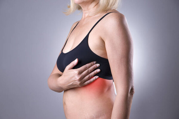 Breast test, woman examining her breasts for cancer, heart attack