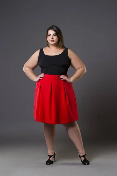 Plus koko muoti malli punainen hame, lihava nainen harmaalla pohjalla, ylipainoinen naisen kehon — kuvapankkivalokuva