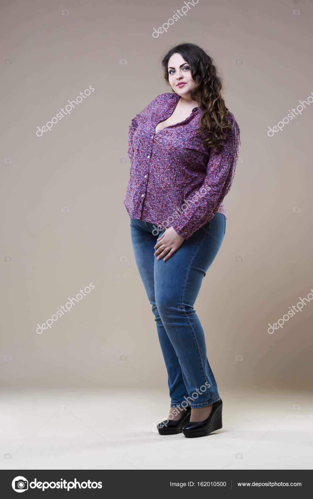 Plus size fashion model in casual clothes, fat woman on beige studio ...