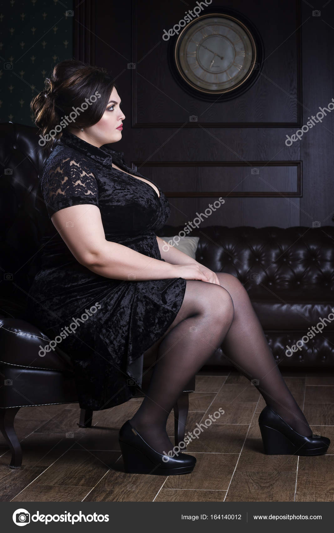 Sexy plus size model in black corset, fat woman with big natural breasts on  dark background, body positive concept Stock Photo