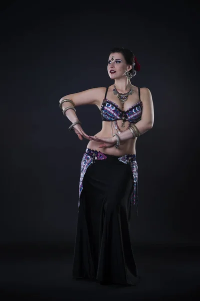 Women performs belly dance in ethnic dress on black background — Stock Photo, Image