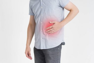 Man with abdominal pain, stomach ache on gray background clipart