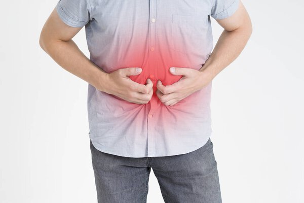 Man with abdominal pain, stomach ache on gray background