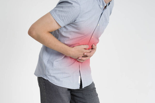 Man with abdominal pain, stomach ache on gray background