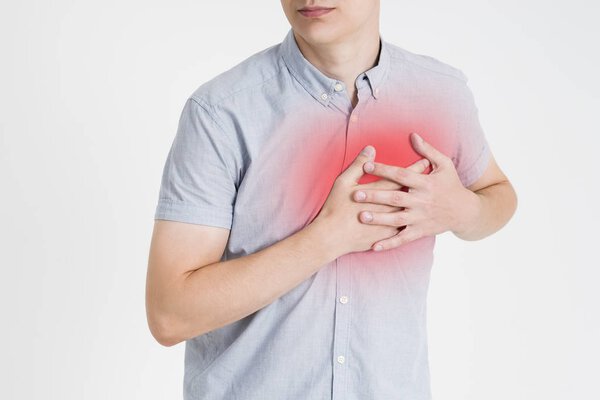 Heart attack, man with chest pain on gray background