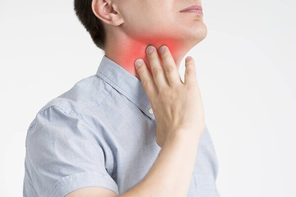 Sore throat, men with pain in neck, gray background