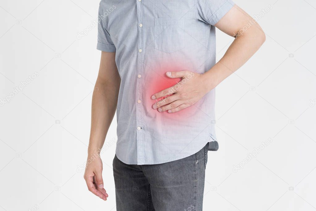 Man with abdominal pain, stomach ache on gray background