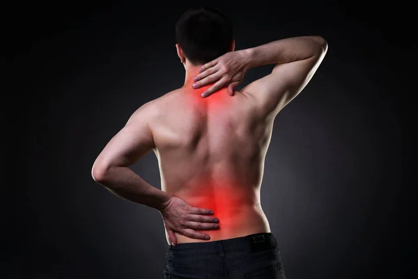 Back pain, man with backache on black background — Stock Photo, Image