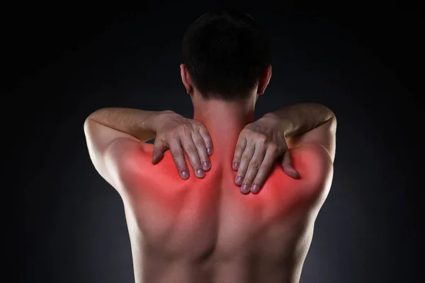 Neck pain, man with backache on black background — Stock Photo, Image