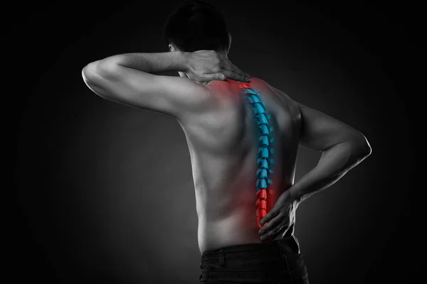 Pain in the spine, a man with backache, injury in the human back and neck