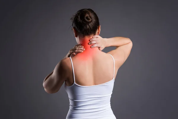 Neck pain, woman with backache on gray background — Stock Photo, Image