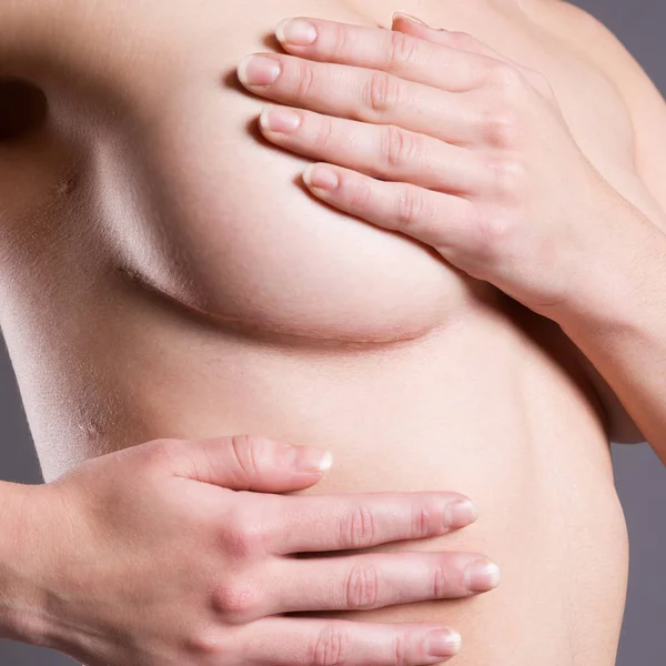 Woman examining her breasts for cancer, scar on female body — Stock Photo, Image