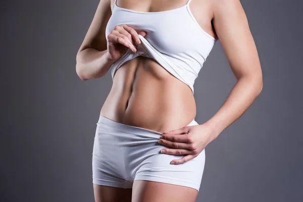 Slim woman in white underwear on gray studio background, perfect female body — Stock Photo, Image