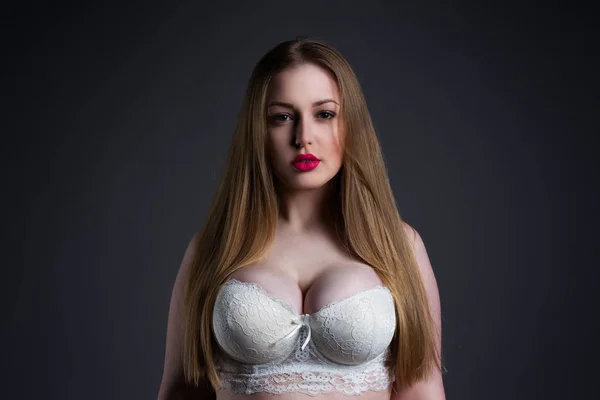 Modelo sexy de tamaño grande en sujetador blanco, mujer gorda con gran pecho natural sobre fondo de estudio gris, cuerpo femenino con sobrepeso — Foto de Stock