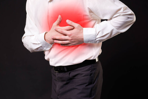Heart attack, man with chest pain on black background