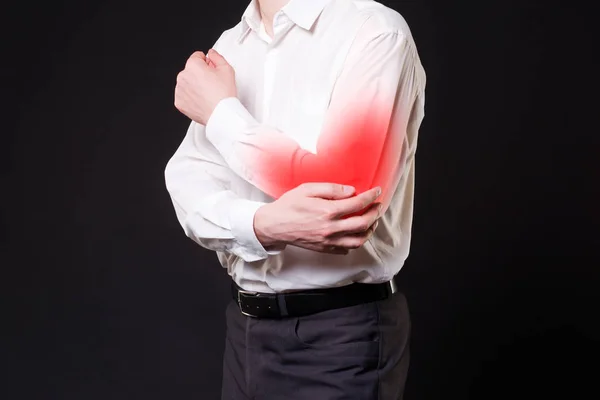 Pain in elbow, joint inflammation with red dot on black background — Stock Photo, Image