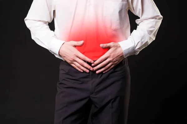 Man with abdominal pain, stomach ache on black background — Stock Image Man with abdominal pain, stomach ache on black background Royalty Free Stock Photos