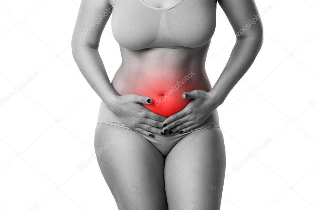 Woman with abdominal pain, stomachache isolated on white background, studio shot with red dot