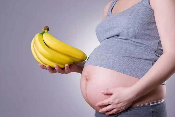 Pregnancy Nutrition Pregnant Woman Bananas Hand Gray Background Studio Shot — Stock Photo, Image