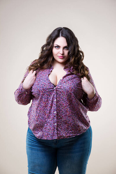 Sexy plus size model in casual clothes, fat woman on beige background, body positive concept