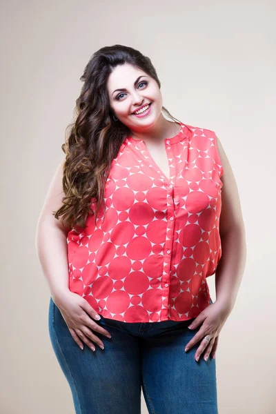 Plus size fashion model in casual clothes, fat woman on beige