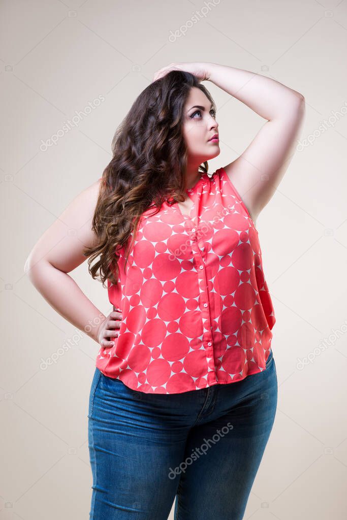 Plus size fashion model in casual clothes, cheerful fat woman on beige background, body positive concept